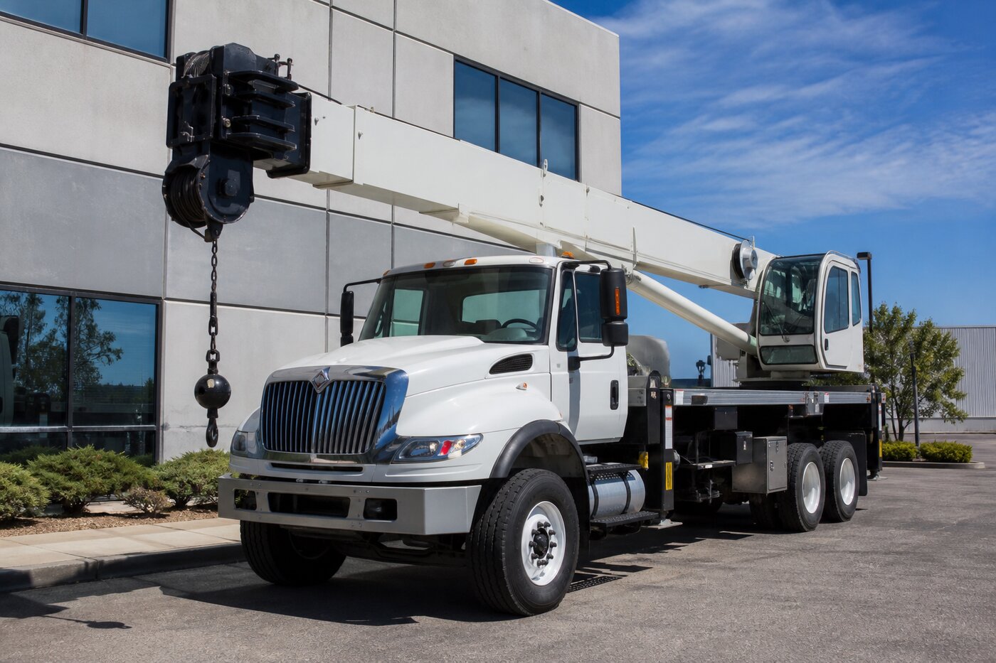 Boom truck with telescoping crane on a commercial site